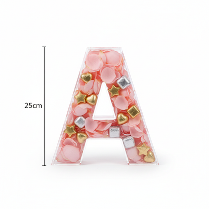 Close-up of single clear 25cm letter A box filled with rose petals and chocolates